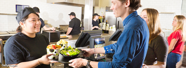 Staff serving customers in fast food restaurant