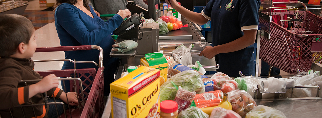 Mom with child paying for groceries