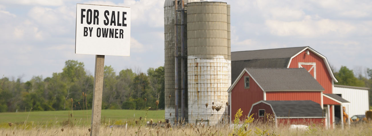 For sale sign by silos