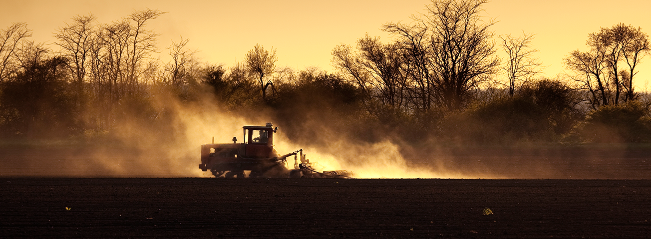 Sepia-toned photo of tractor working a field