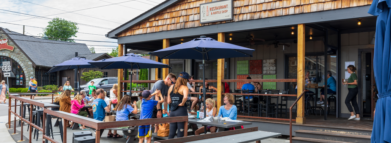 A photo of people dining on a restaurant patio