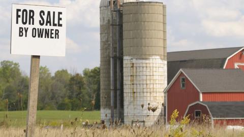 For sale sign by silos