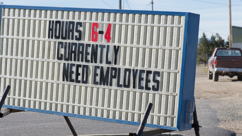 Sign board in rural setting advertising need for employees