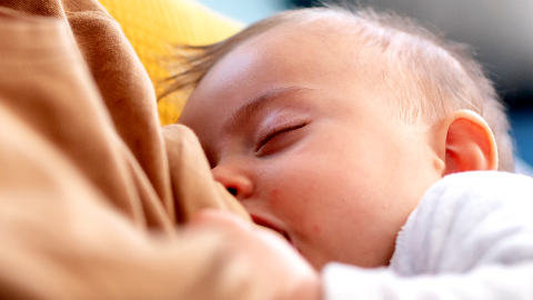 Photo of infant breastfeeding.