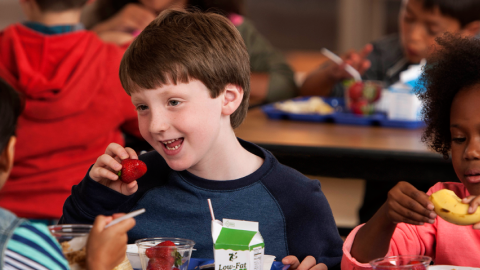 Photo of children eating in a school cafeteria.